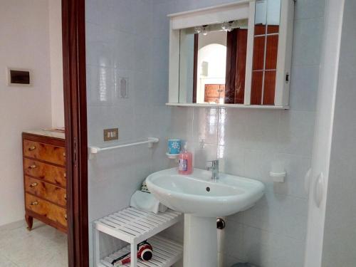 a bathroom with a sink and a mirror at Ancilinas House in Castellammare del Golfo