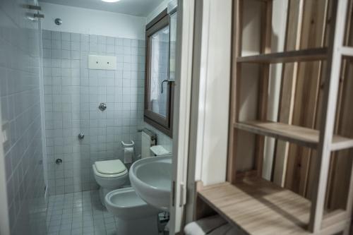 a small bathroom with a toilet and a sink at La casa del pescatore: a lovely escape in Venice!! in Venice