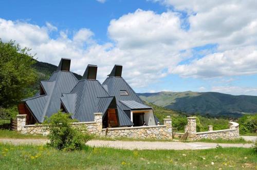 a house with a roof on top of a hill at Vila Piramida in Bitola