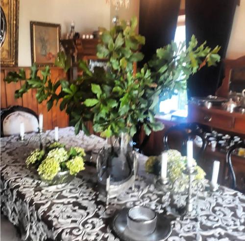 a table with a black and white table cloth with flowers at A Hotel Boutique Pelluhue in Pelluhue