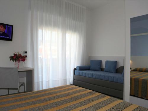 Ένα ή περισσότερα κρεβάτια σε δωμάτιο στο Hotel Pillon