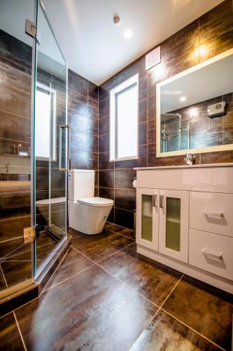 a bathroom with a toilet and a sink and a shower at Alpine Hotel in Christchurch