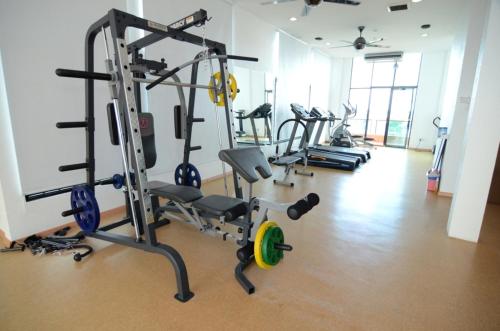 a gym with several tread machines in a room at Crystal Lodge in Kota Bharu
