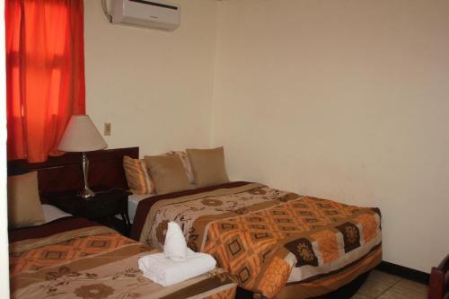 Giường trong phòng chung tại Hotel Villa Angelo