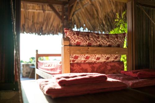 a room with a bed with towels on it at Utopia Rote Lodge in Nembrala