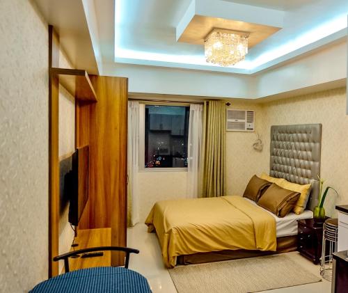 a hotel room with a bed and a window at Avida Towers Davao in Davao City