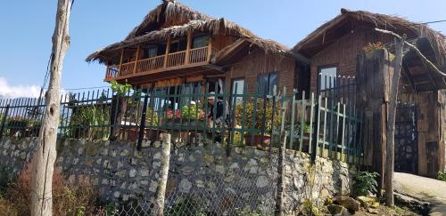 a man standing on the balcony of a house at Tavan View Homestay in Sa Pa