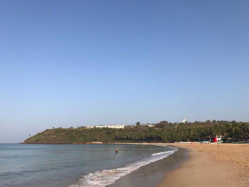 a beach with a person swimming in the water at All Seasons Guest House in Vasco Da Gama