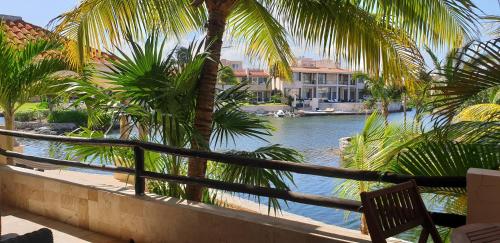 a view of a body of water with palm trees at Condo Bellmare in Puerto Aventuras
