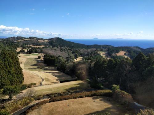 a view of the ocean from the top of a hill at Izu Hokkawa Seaside Guesthouse 伊豆北川の家 in Higashiizu