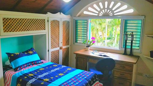 a bedroom with a desk and a bed and a window at A La Dolce Vita Beachfront Hotels, Las Terrenas, Samana in Las Terrenas