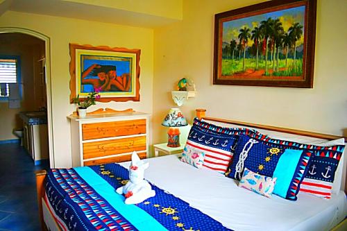 a bed with a teddy bear sitting on top of it at A La Dolce Vita Beachfront Hotels, Las Terrenas, Samana in Las Terrenas