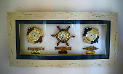 four clocks are on a wall in a frame at A La Dolce Vita Beachfront Hotels, Las Terrenas, Samana in Las Terrenas