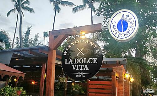 a sign for a la dolce vita restaurant at A La Dolce Vita Beachfront Hotels, Las Terrenas, Samana in Las Terrenas
