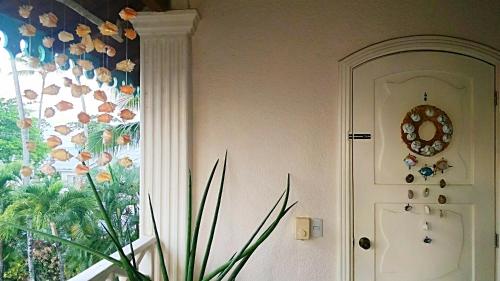 a plant in front of a window with a flower mural at A La Dolce Vita Beachfront Hotels, Las Terrenas, Samana in Las Terrenas