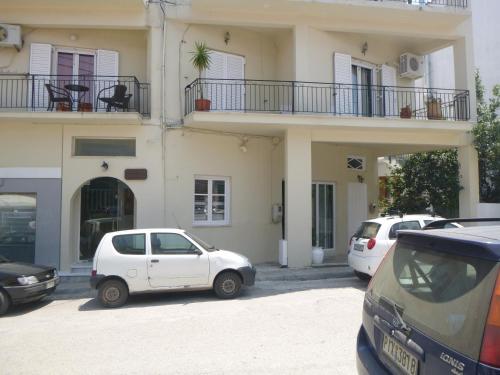 a white car parked in front of a building at Karafelas Hotel in Skiathos Town