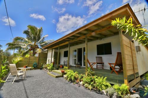 a small house with a patio and a tv at ShineAwayHomes - Mountain View AIR CONDITIONED in Rarotonga