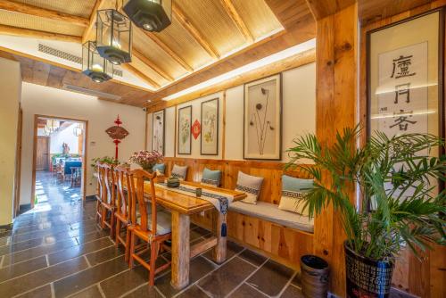 a dining room with a wooden table and chairs at Zhangjiajie National Park Yuelu Homestay in Zhangjiajie