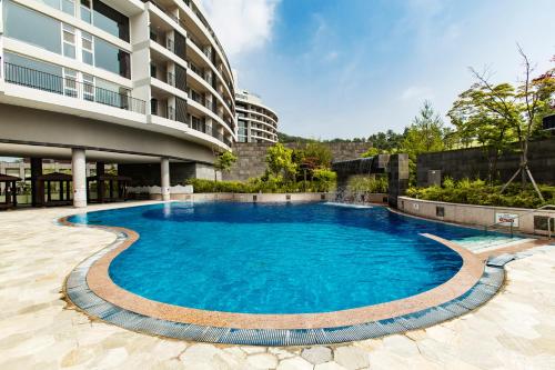 a swimming pool in front of a building at Lotte Buyeo Resort in Buyeo
