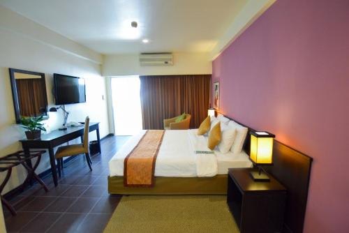 a hotel room with a bed and a desk at The Color Living Hotel in Bangna