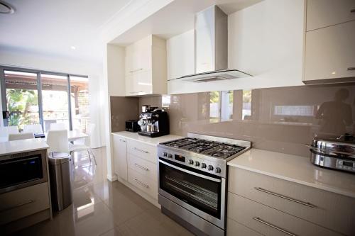 A kitchen or kitchenette at Heated Pool - Peaceful and Relaxing Beachside Family Entertainer