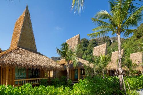 a resort with palm trees in front of it at Phi Phi CoCo Beach Resort in Phi Phi Don