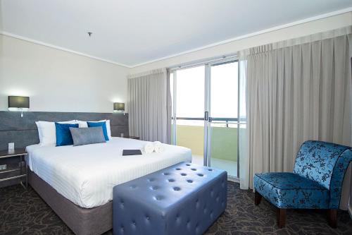 a hotel room with a bed and a chair at The Lord Forrest Hotel in Bunbury