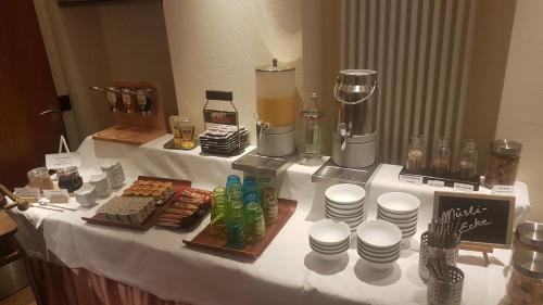 a white table with food and drinks on it at Hotel Restaurant Rothkopf in Euskirchen