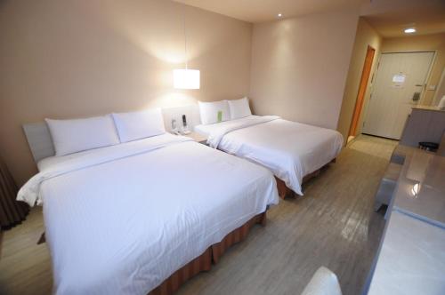 เตียงในห้องที่ Kindness Hotel - Houyi Jiuru