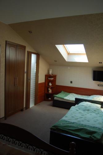 a bedroom with two beds and a skylight at DOM WESELNY ,, ANNA'' in Warlubie