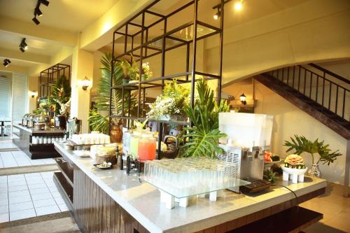 a restaurant with a buffet of food on a counter at Forest Crest Nature Hotel and Resort Powered by ASTON in Nasugbu