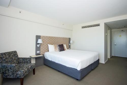 a hotel room with a bed and a chair at The Lord Forrest Hotel in Bunbury