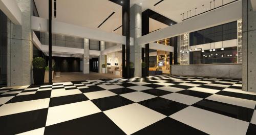 an empty lobby with a black and white checkered floor at Citadines Gaoke Liangjiang Chongqing in Chongqing