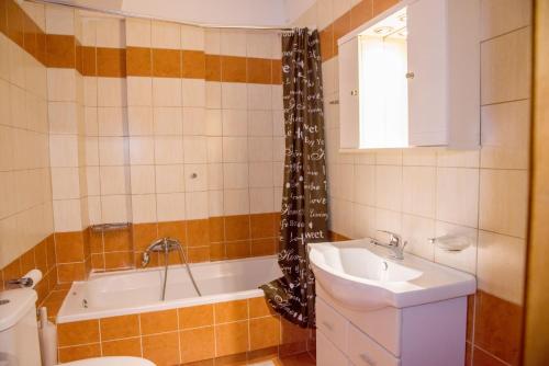 a bathroom with a sink and a tub and a toilet at Corfu Don Camillo Apartment in (( Agía Eleoúsa ))