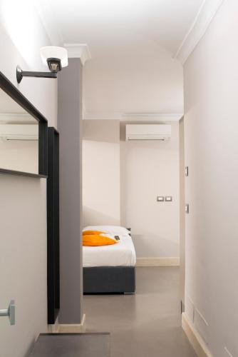 a bedroom with a bed with an orange blanket at Principessa Mafalda in Messina