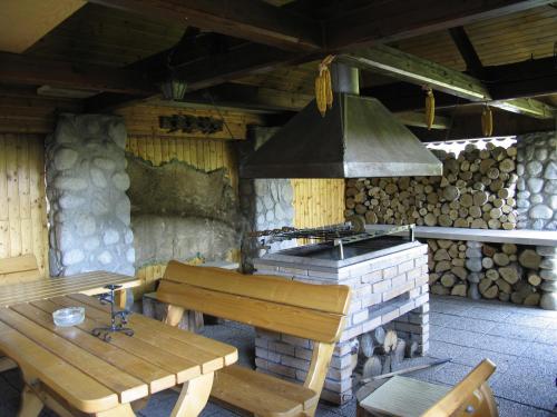 an outdoor kitchen with a stove and a wooden table at Ubytovanie 184, Bed and Braekfast 184 in Stará Lesná