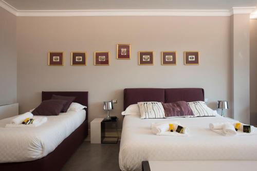 two beds sitting next to each other in a room at Principessa Mafalda in Messina