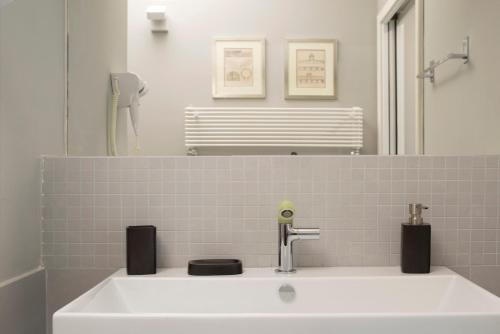 a white sink in a bathroom with a mirror at Principessa Mafalda in Messina