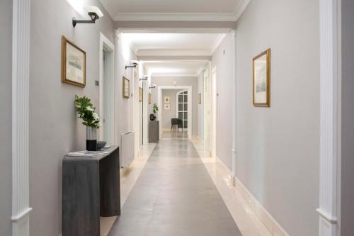 a hallway with white walls and a long hallway at Principessa Mafalda in Messina