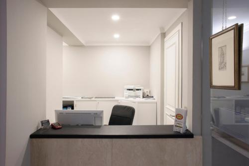 an office with a desk with a computer and a chair at Principessa Mafalda in Messina