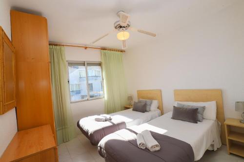 a bedroom with two beds and a window at DIFFERENTFLATS Dms in La Pineda