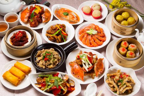 a table with many plates of food on it at HiONE Holiday Hotel in Shenkeng