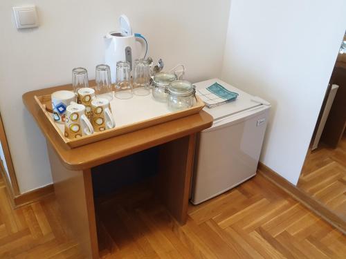 a table with glasses and other items on it at Spirit Hostel and Apartments in Belgrade