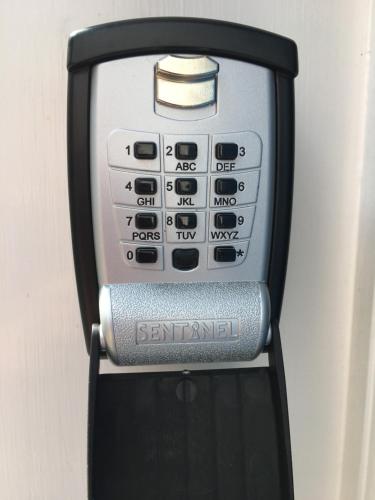 a close up of a cell phone in a holder at The Garden Room Apartment in Cardigan