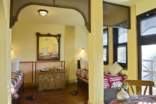 a room with two beds and a mirror at Hotel Empress Zoe in Istanbul