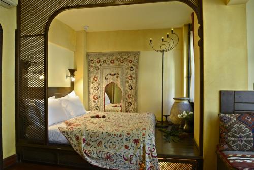 a bedroom with a bed with a large mirror at Hotel Empress Zoe in Istanbul