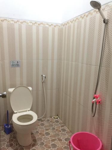 a bathroom with a toilet and a shower at Asta Homestay in Karimunjawa