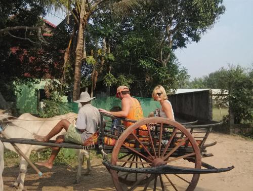 a group of people sitting on a horse drawn carriage at Sok Phen Homestay in Siem Reap