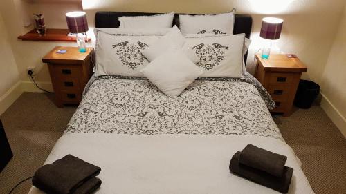 a bedroom with a large bed with pillows at Doric House in Inverness