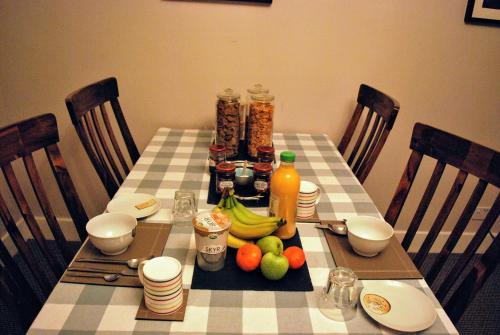 a table with fruit and juice on top of it at Doric House in Inverness